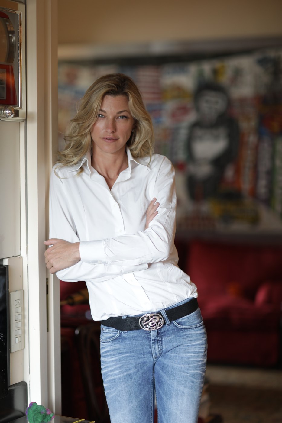 Nicole Junkermann in piedi sulla soglia di una stanza luminosa, un ritratto disteso
